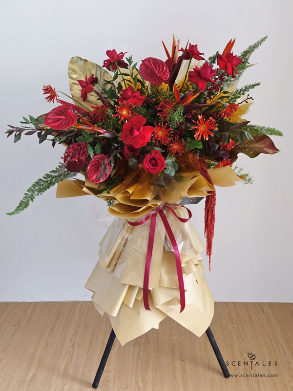 Fresh flower stand with Red rose, red gerbera pasta, red anthurium, red five friendship orchid, red calimero pompom, fox tail, bird of paradise, rain forest leave, preserved red/maroon amaranthus, plenty of fish tail fern asparagus, spiraea leave and eucalyptus