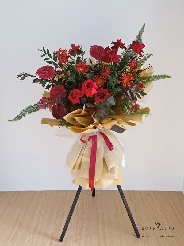 Red Majesty Opening Flower Stand Fresh flower stand with Red rose, red gerbera pasta, red anthurium, red five friendship orchid, red calimero pompom, fox tail, plenty of fish tail fern asparagus, spiraea leave and eucalyptus